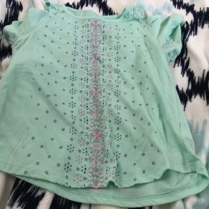 Cute girls teal shirt with slit in the shoulders